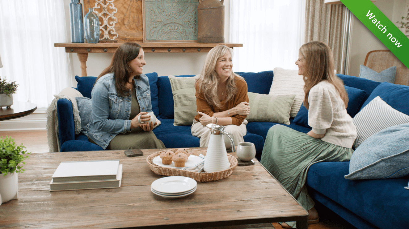 three_women_sitting_on_couch